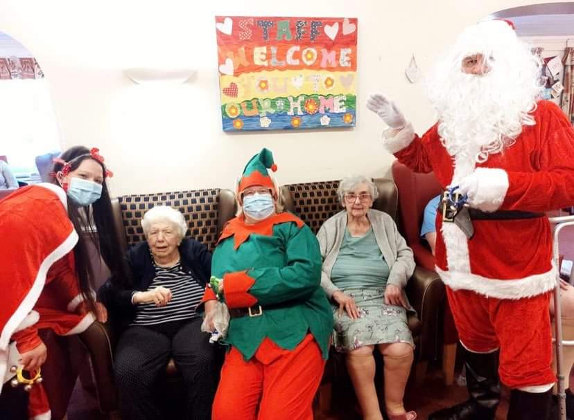 Santa with residents, employees, and families of the residents