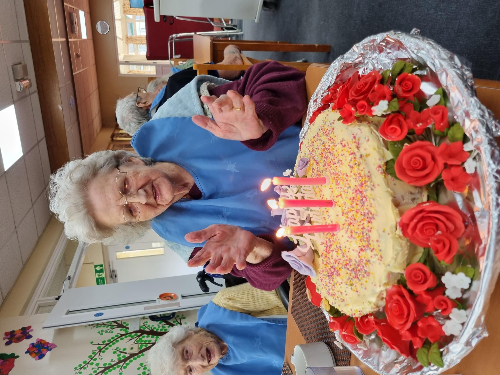 Resident with their birthday cake 