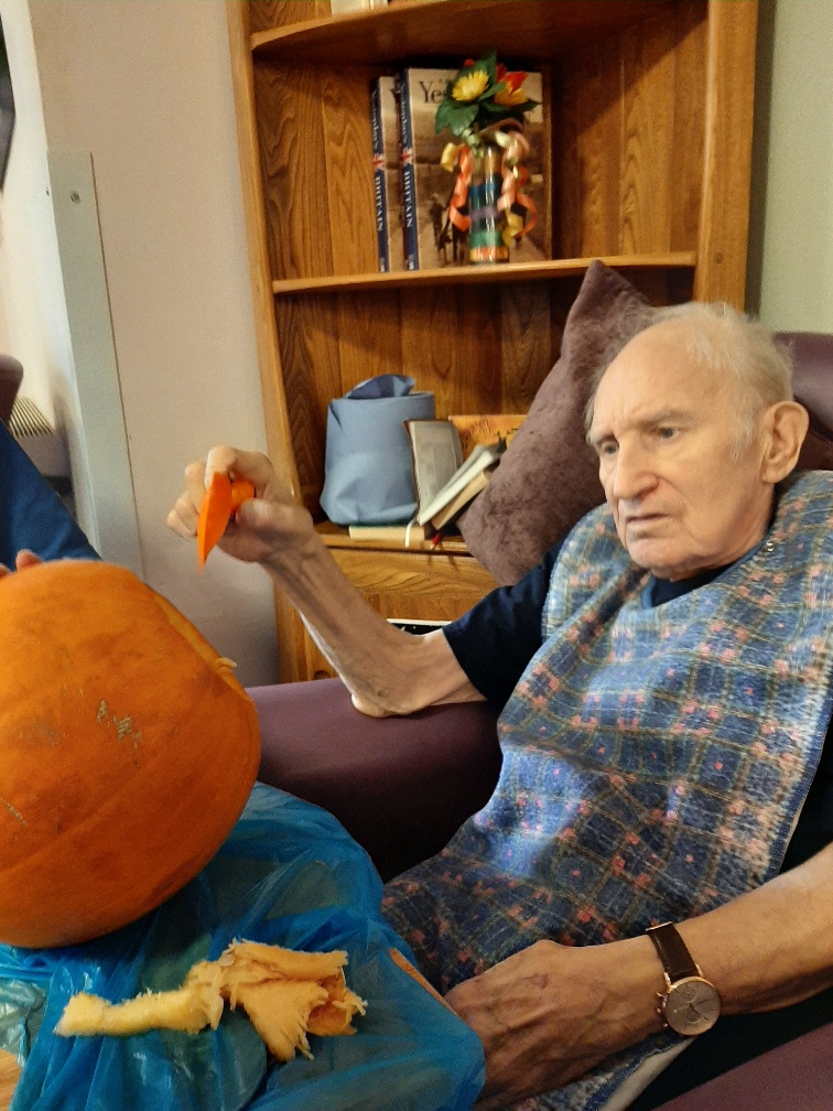 resident carving a pumpkin 