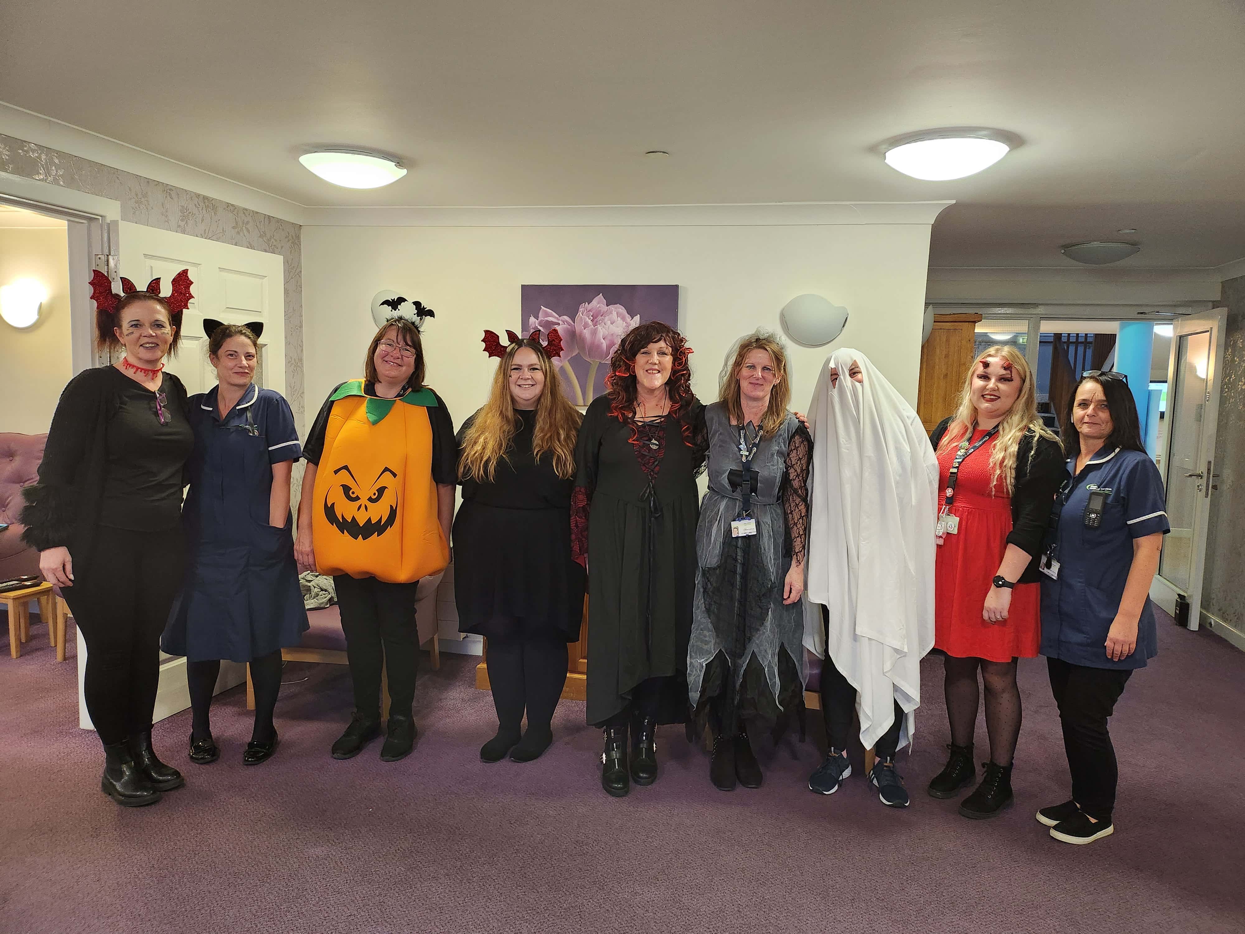 Employees dressed up in different Halloween costumes 