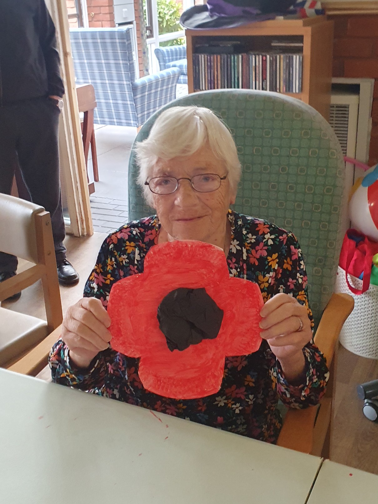 resident making a poppy out of paper plates