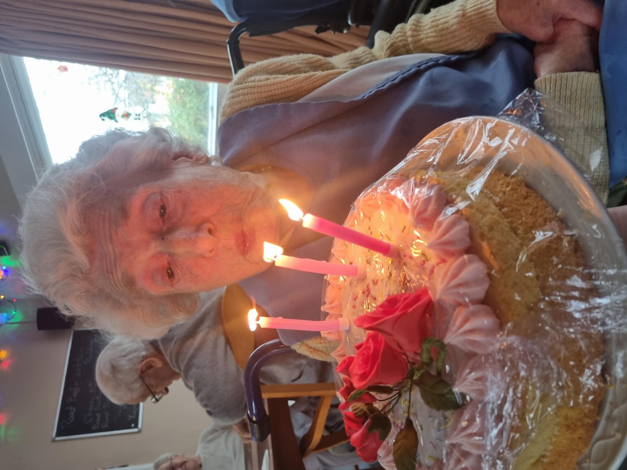 Vera blowing out candles on her birthday cake 