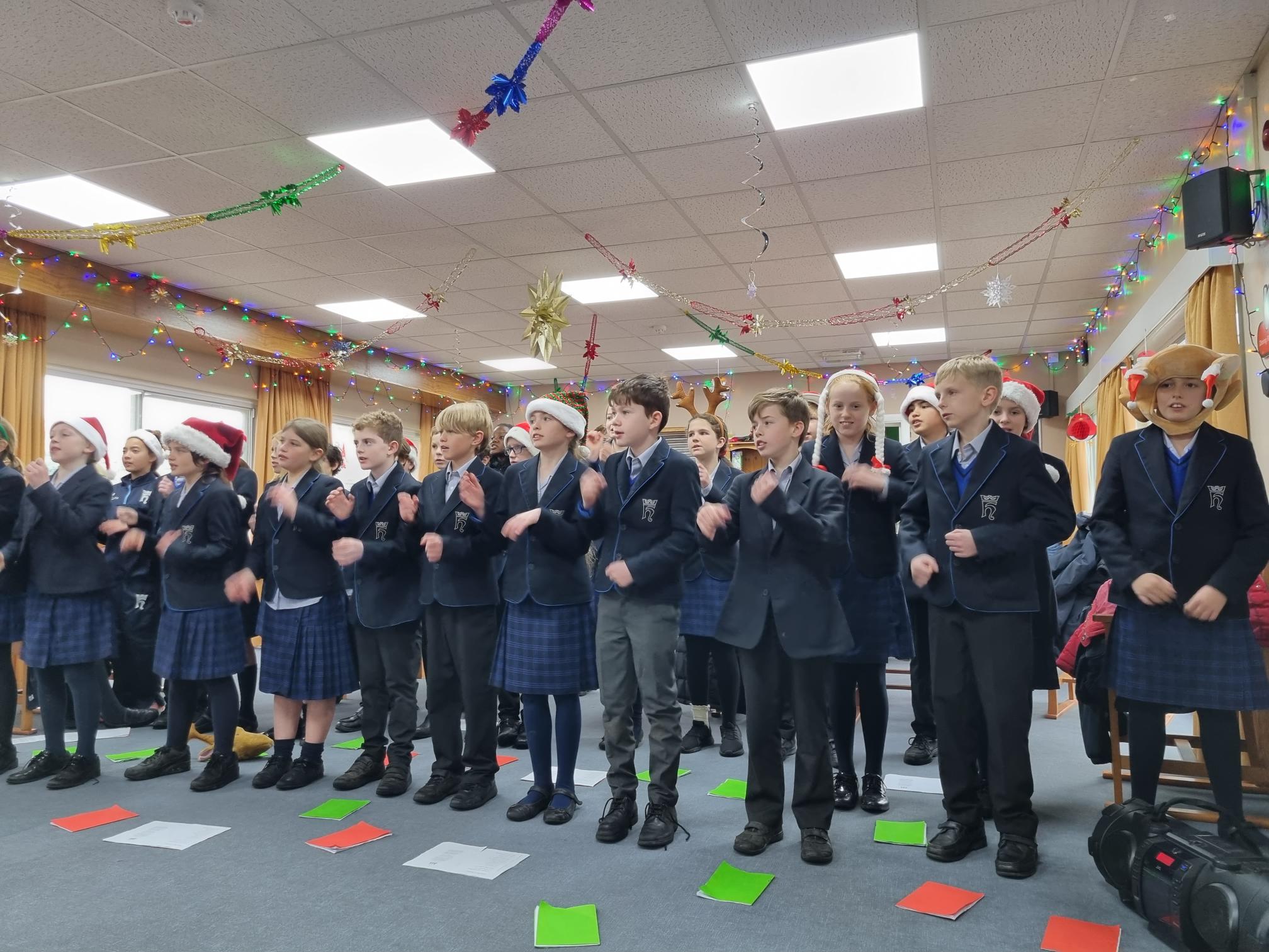 students from Christ Collage singing Christmas carols 