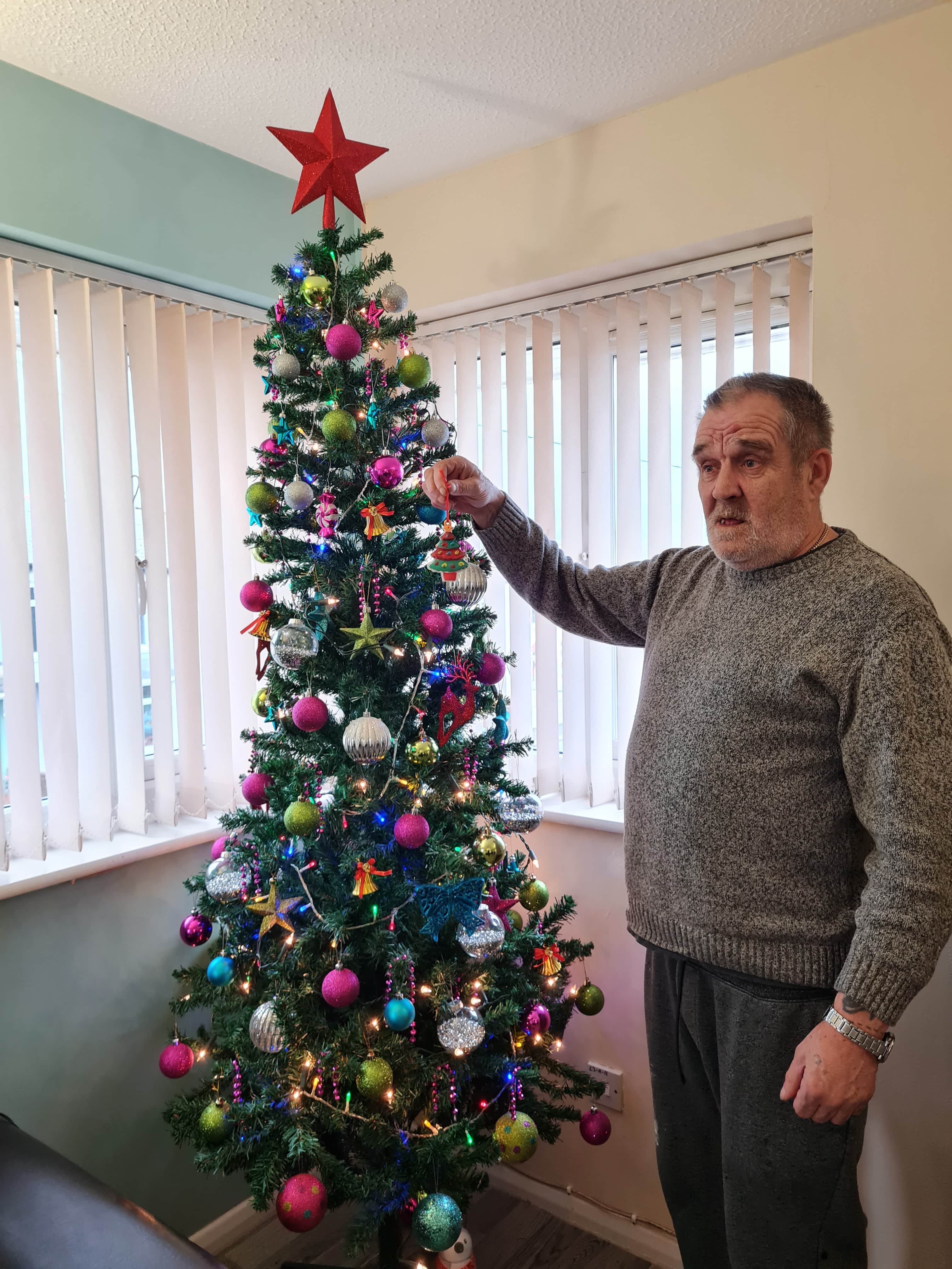 resident with Christmas tree