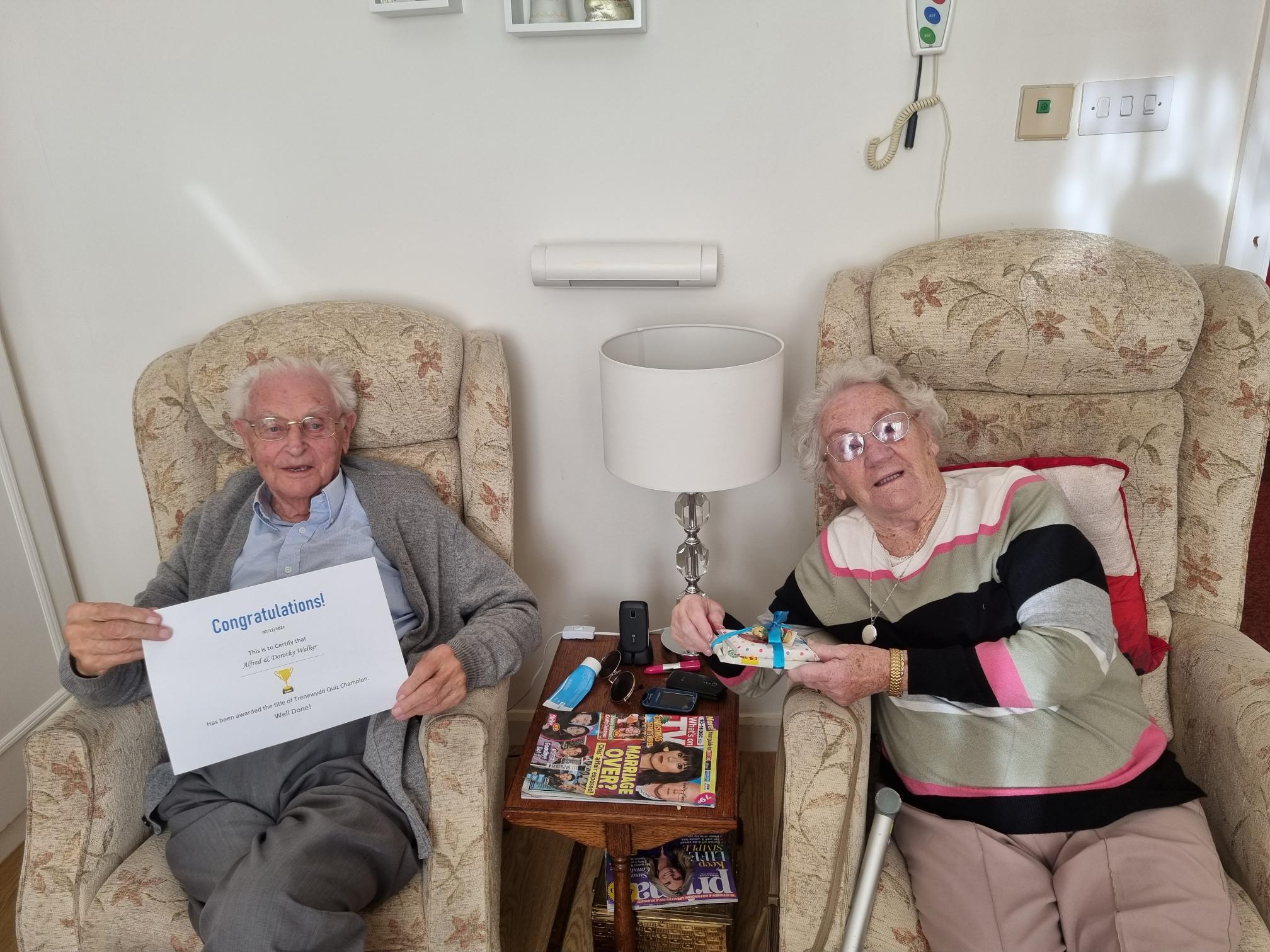 residents who won the quiz holding up their certificate 
