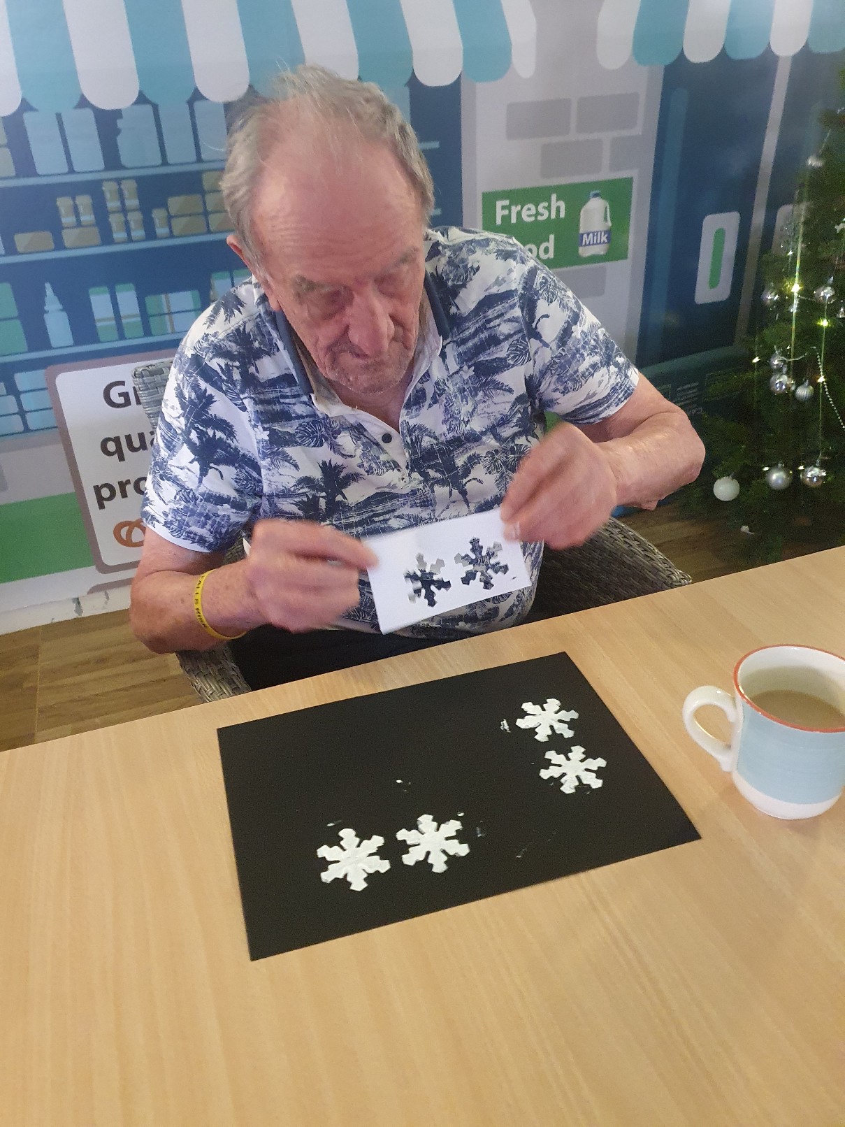 resident making snowflakes using stencils 