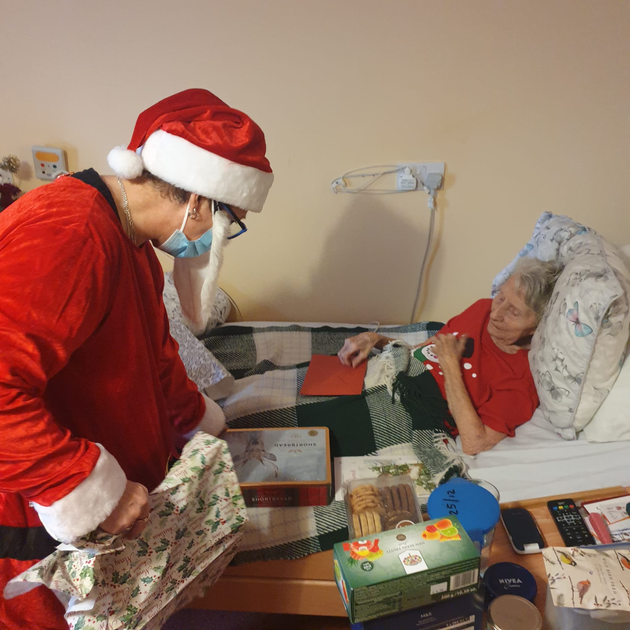 santa giving resident a Christmas present 