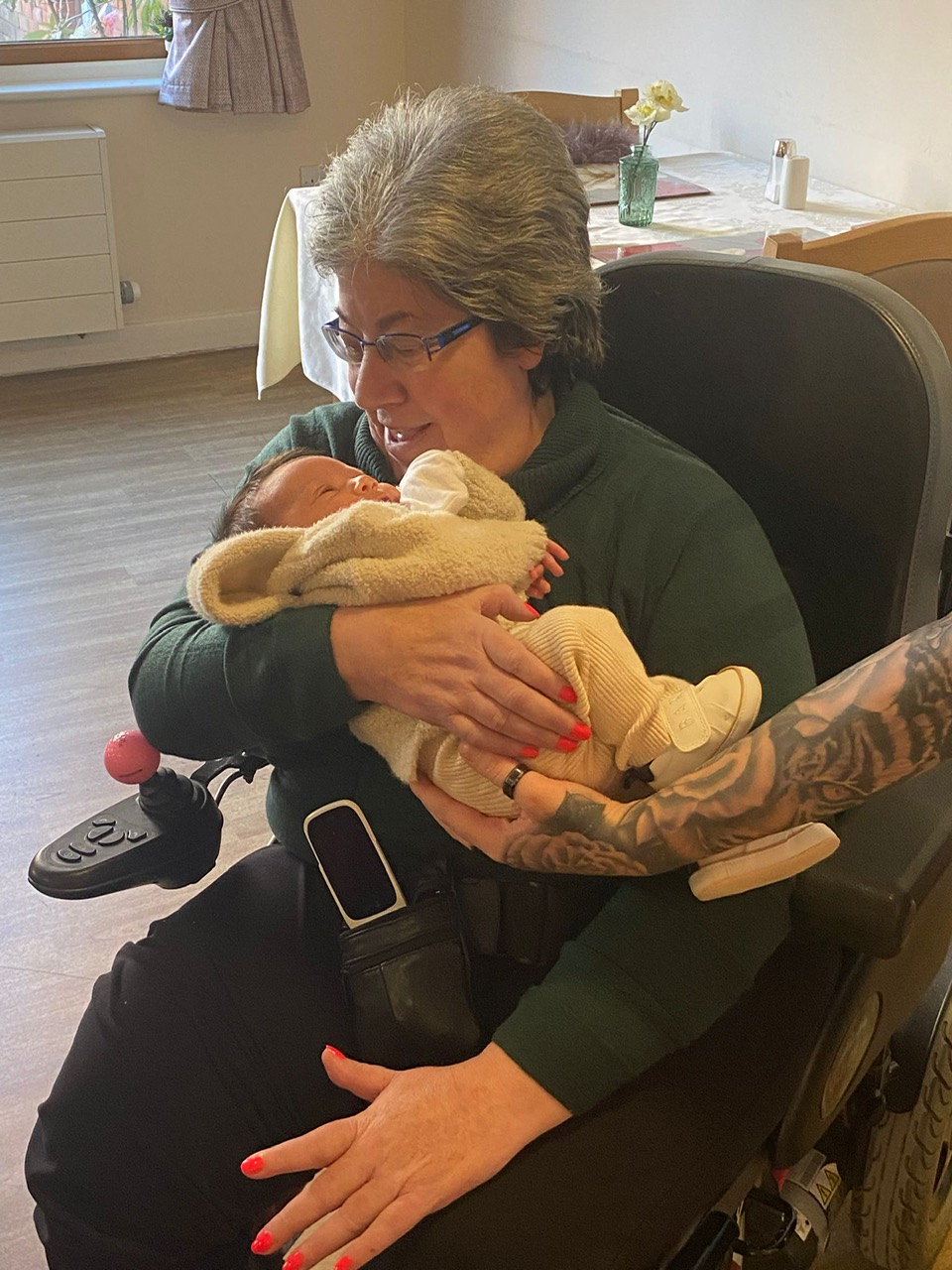 Resident holding baby Milo