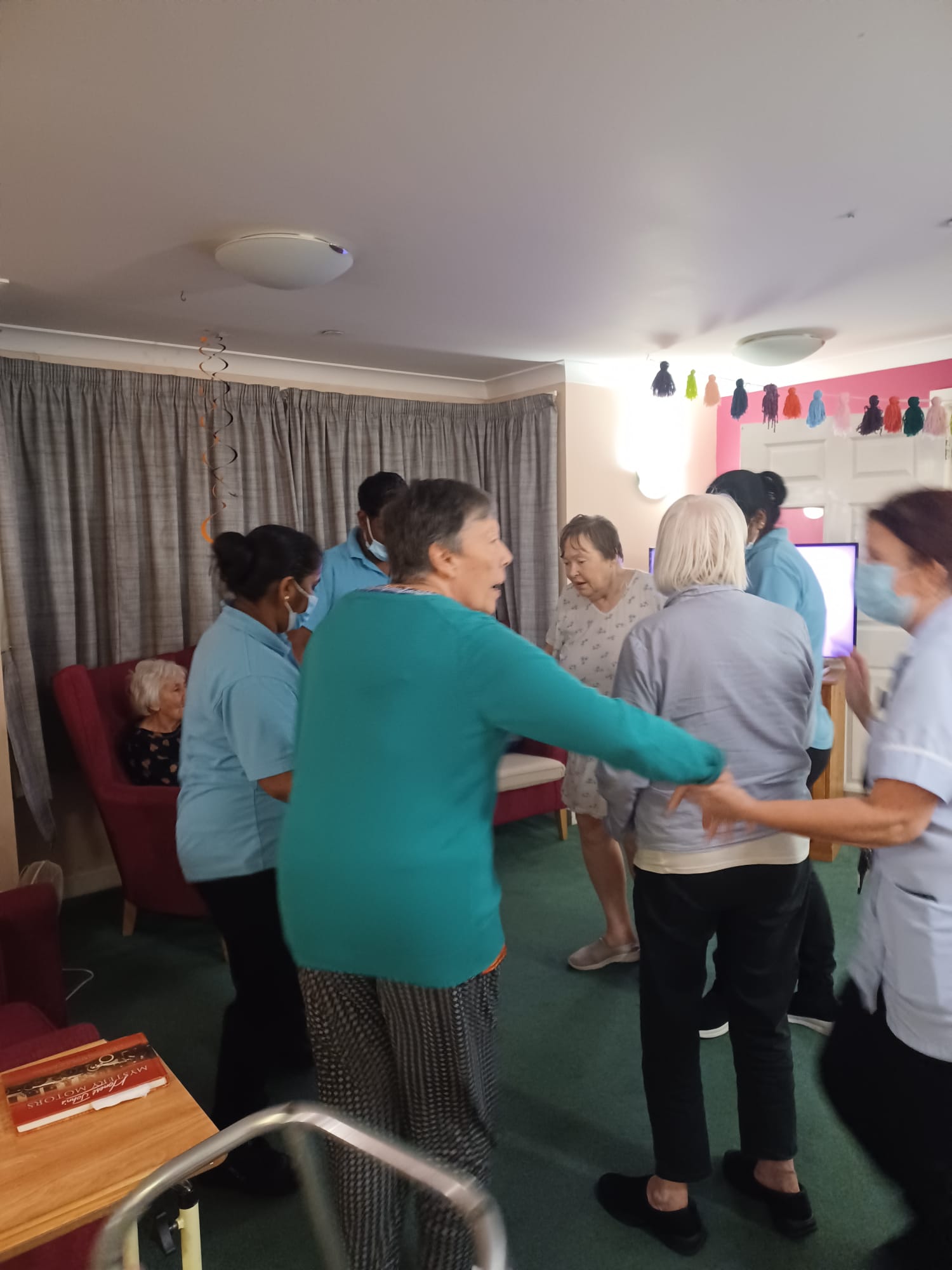 Residents practicing their strictly dancing moves with employees 