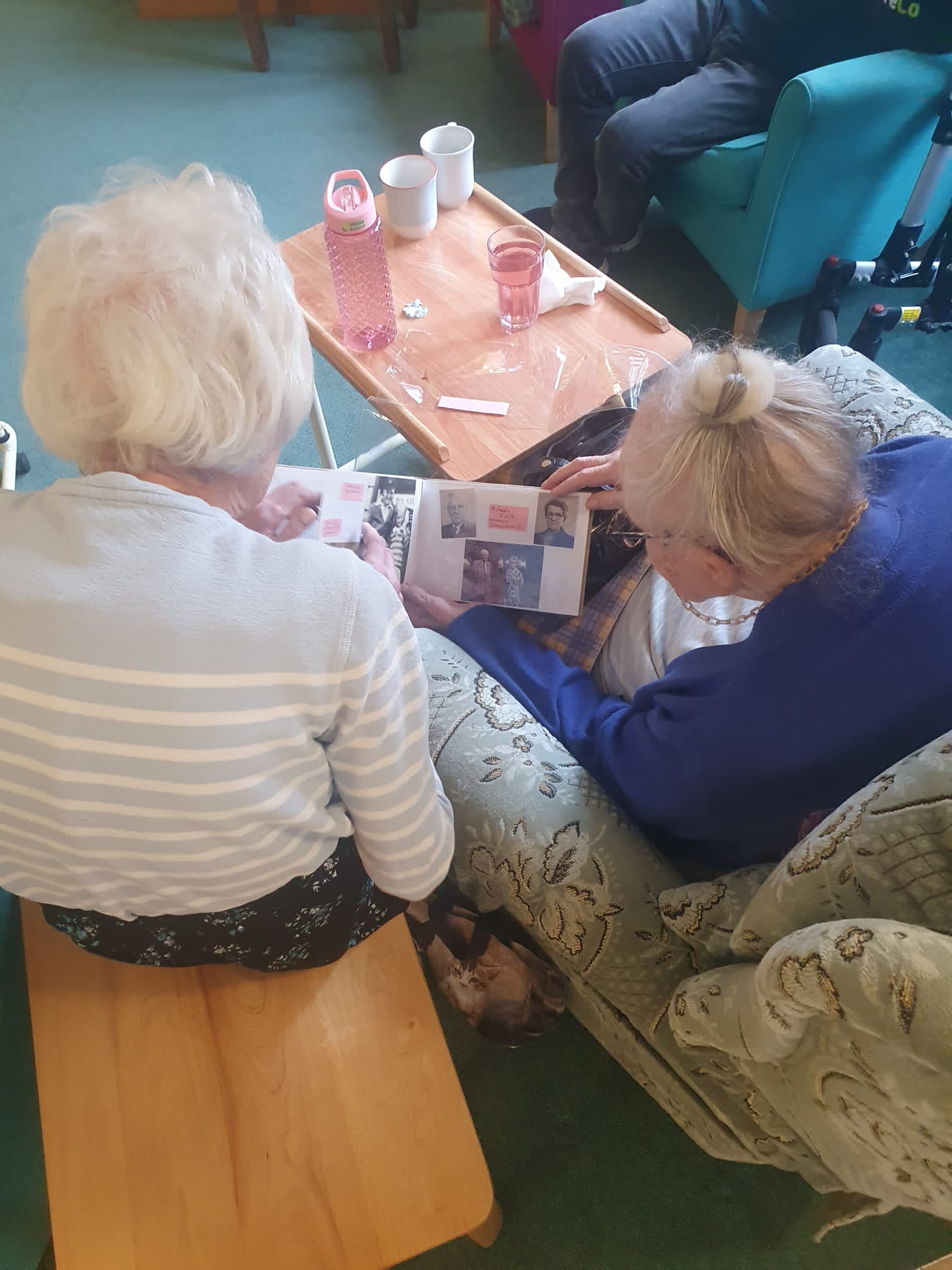 Hilda and Margret reading Hilda's memory book