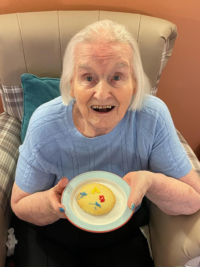 resident with biscuits she has decorated 
