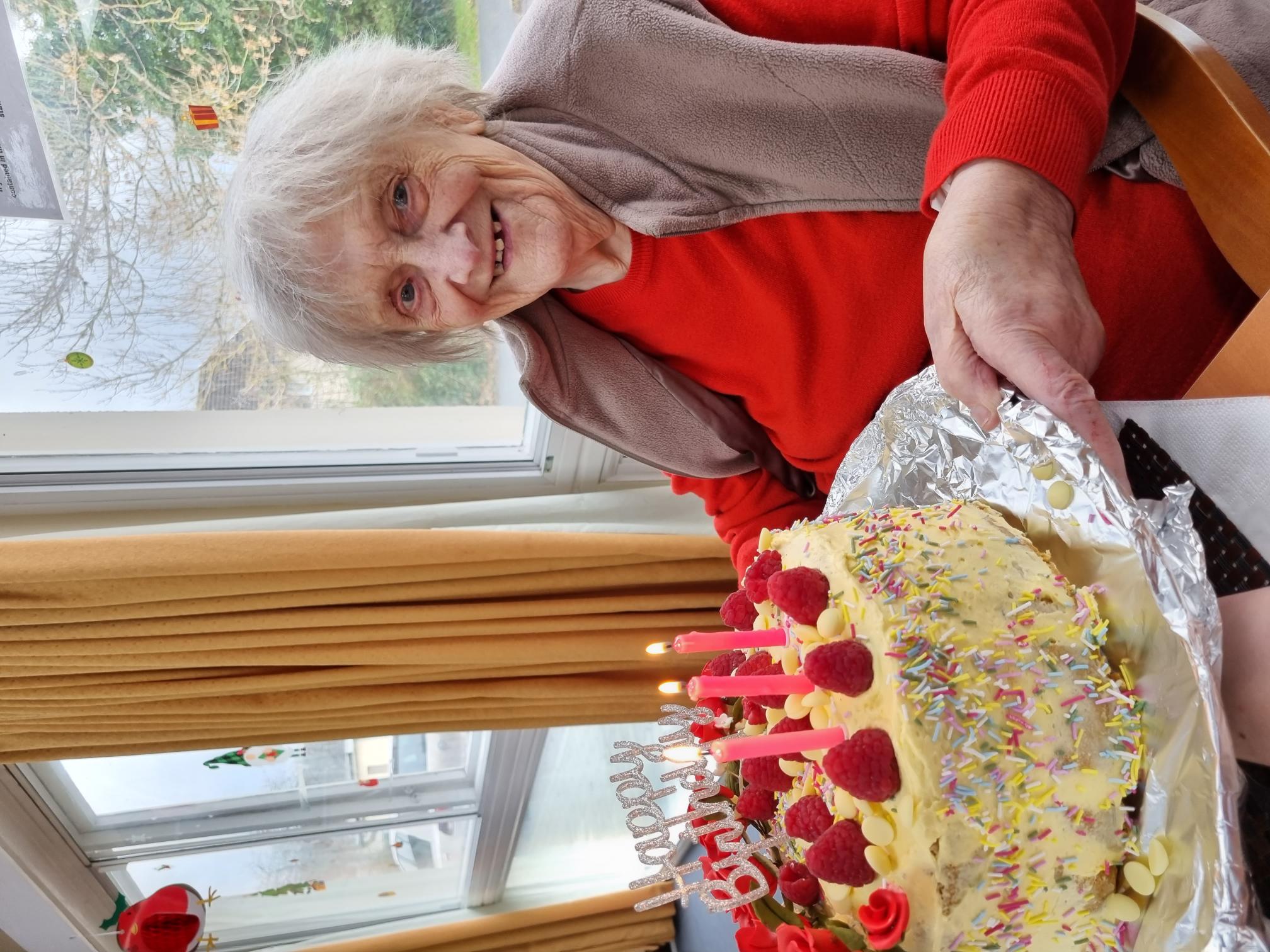 resident with her birthday cake 