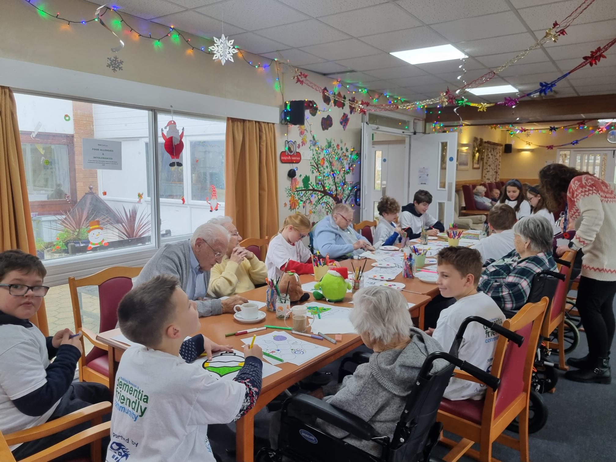 school children doing crafts with residents 