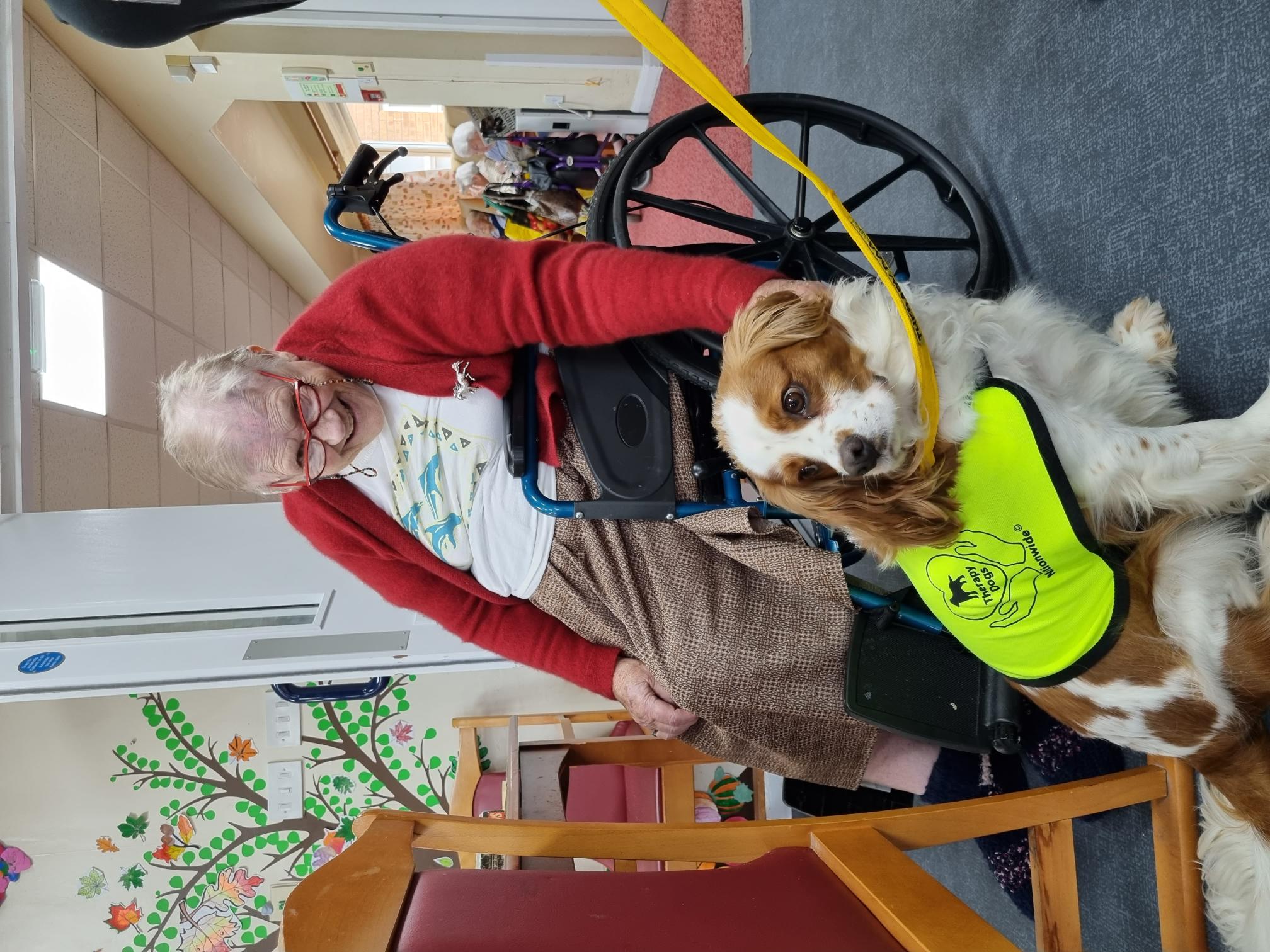 resident with Dougal the therapy dog