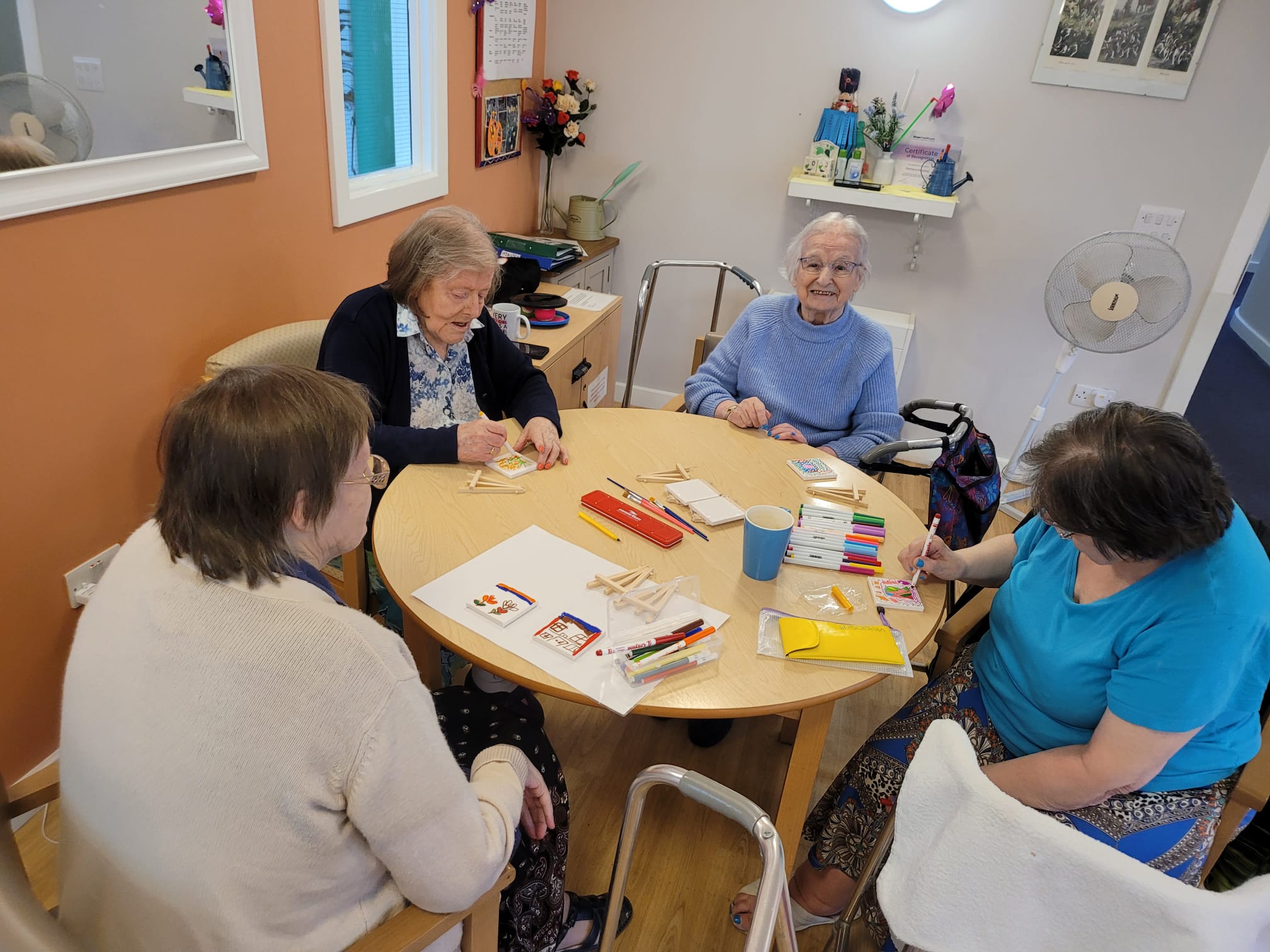 residents painting mini canvases 
