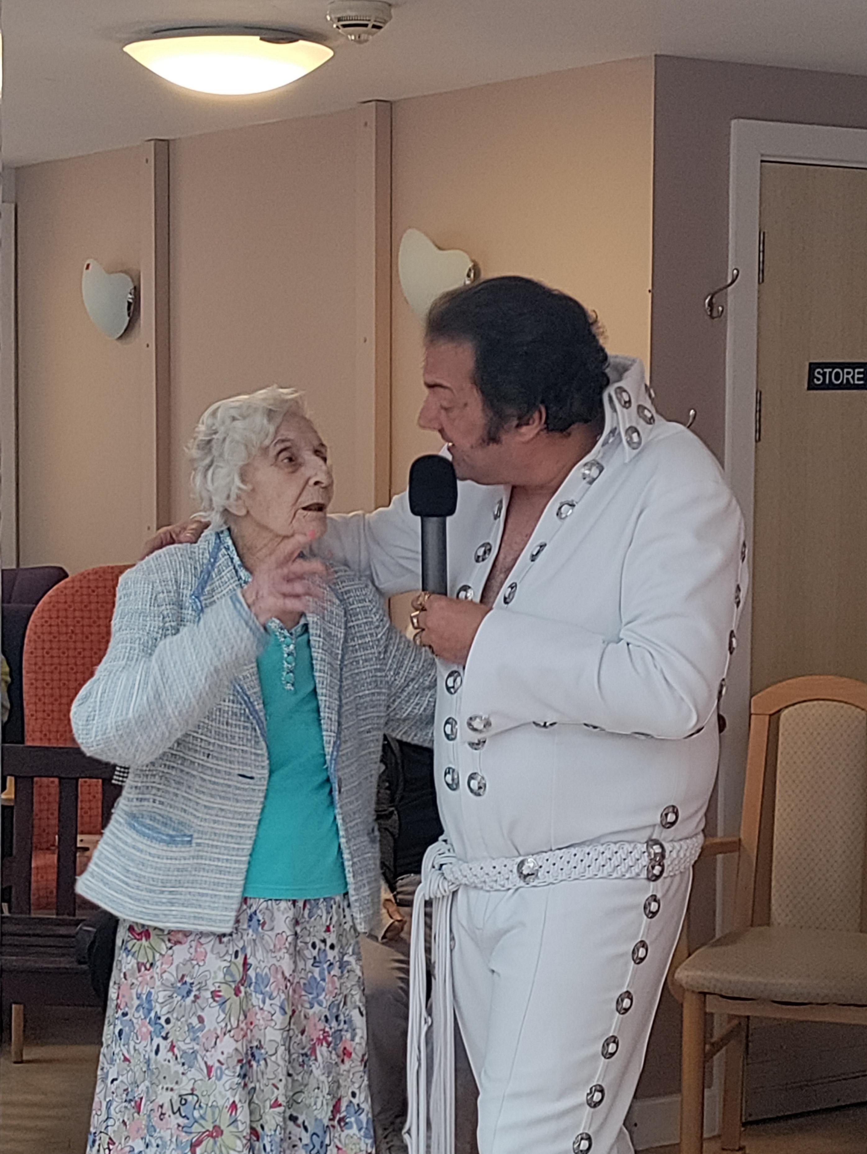 Elvis having a sing with one of the residents 