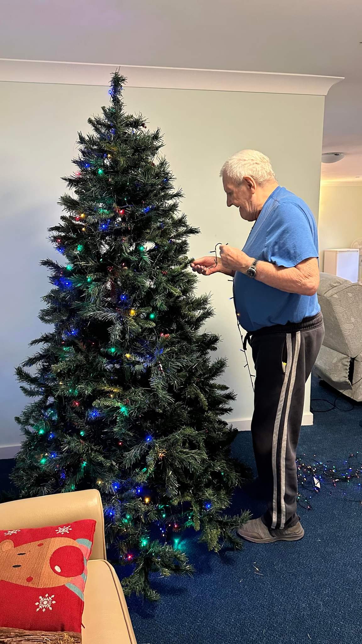 resident decorating Christmas tree