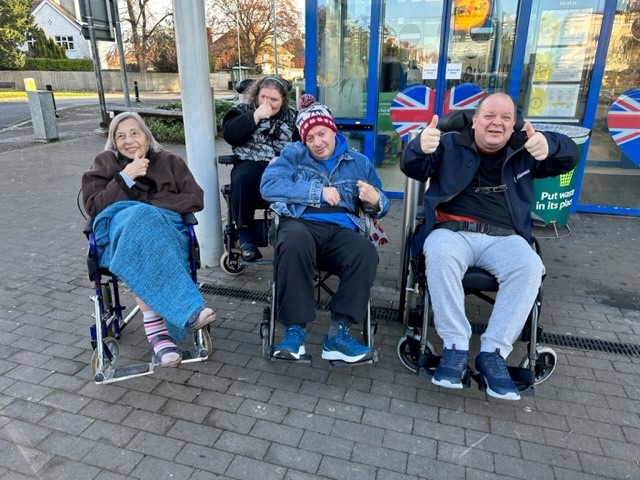 residents with their thumbs up on their walk 